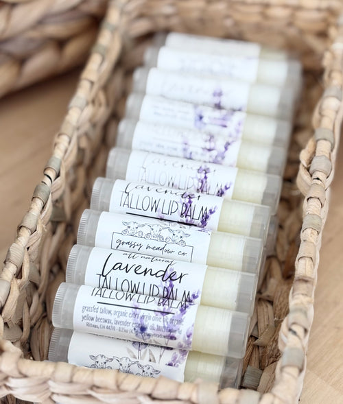 all-natural tallow lip balm made by Grassy meadow Co. in a wooden box on a wooden counter